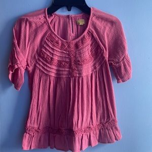A pink blouse with designs on it brand true craft